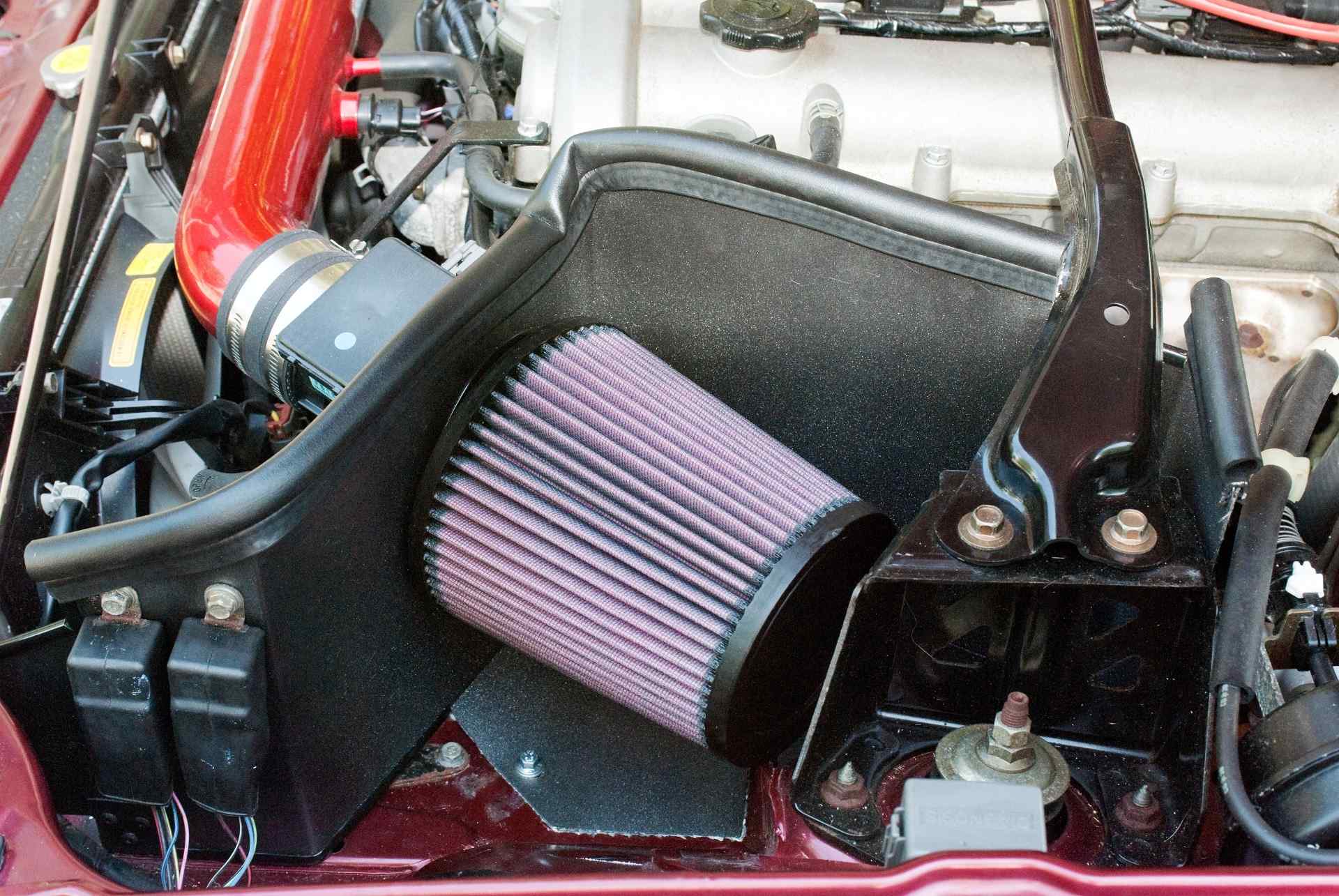 An image of a cold-air intake installed, prominently featuring an insulated air filter