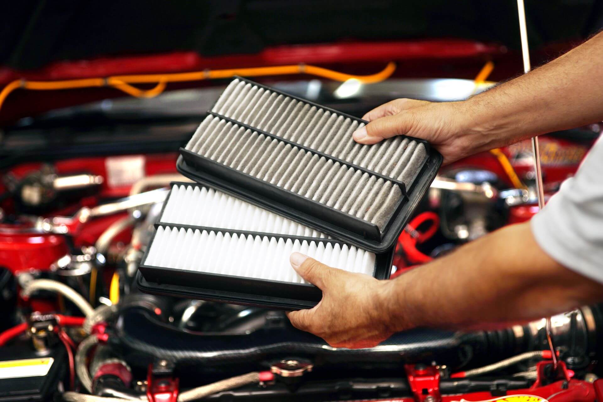 Service technician comparing air filters during professional custom truck service