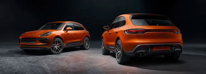 two_orange_porsche_macans_parked