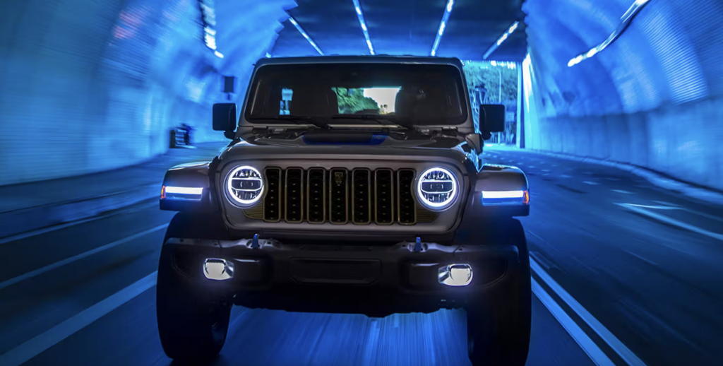 Front view of a 2024 Jeep Wrangler driving through a tunnel with the headlights on