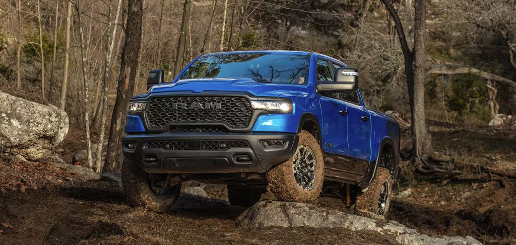 Blue Ram 1500 driving over rocks