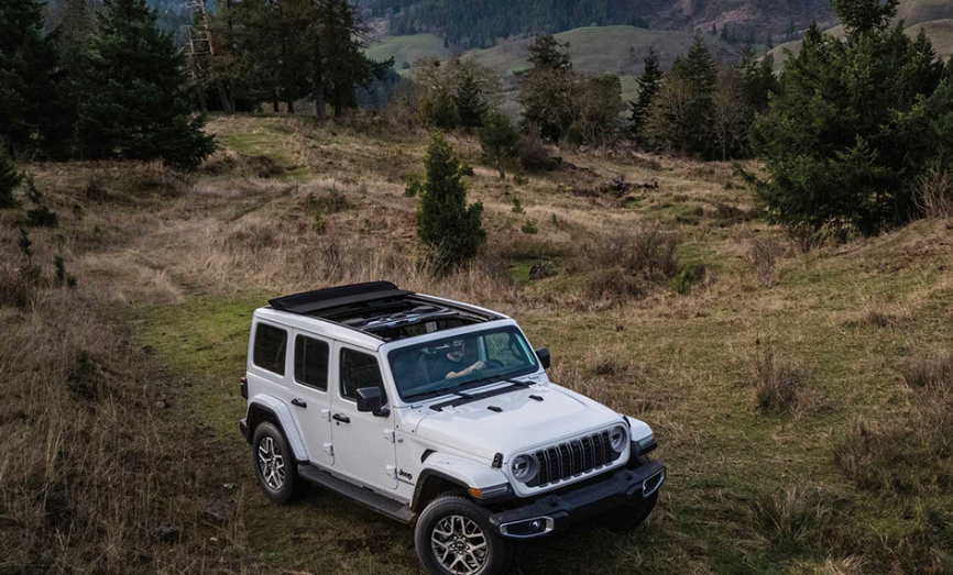 2026 Jeep Wrangler Rubicon parked on Alberta mountain overlanding trail — side view in natural landscape