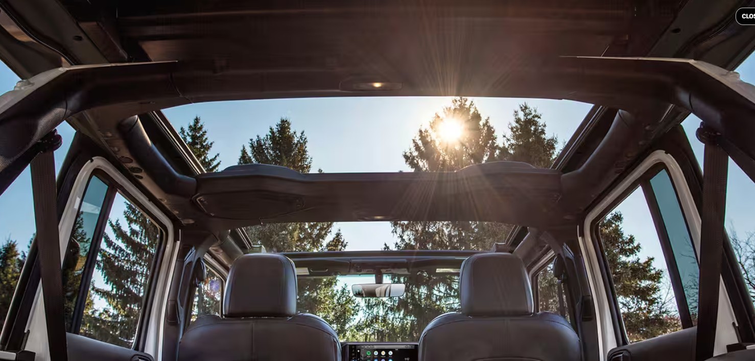2026 Jeep Wrangler parked at St. Albert Dodge with pricing information for Canadian buyers