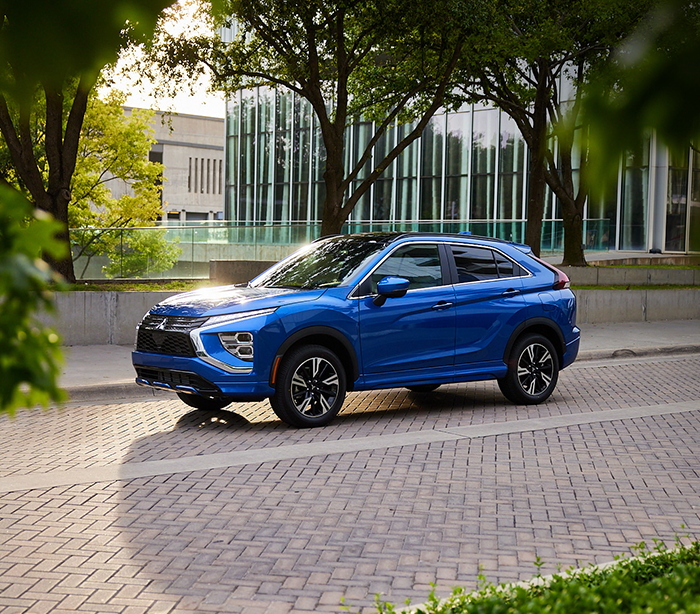 2024 Blue Eclipse Cross SEL Touring parked outside of a business