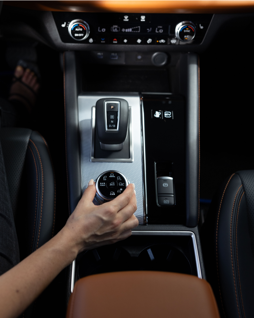 2024 Outlander PHEV SEL interior view of person adjusting a gauge