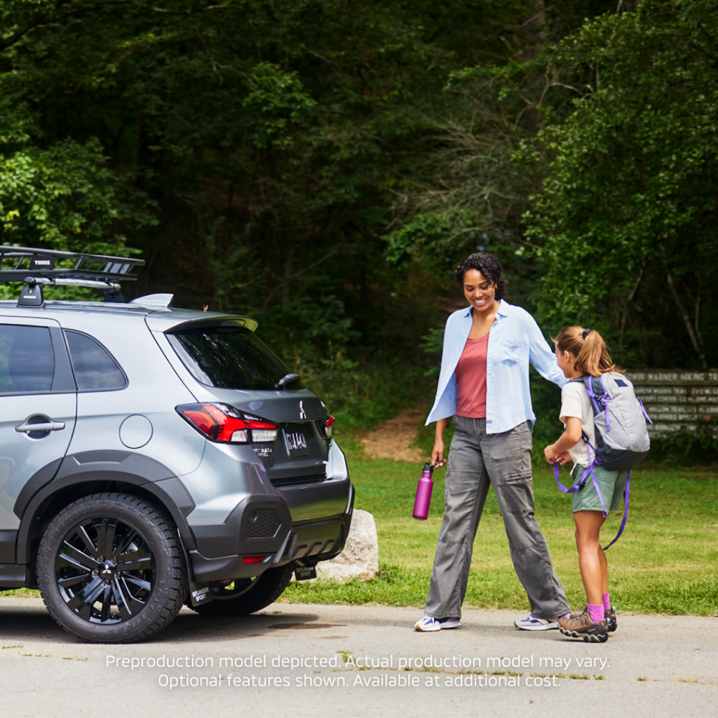 2024 Outlander Sport Trail Edition mom and daughter walking back to car after a hike