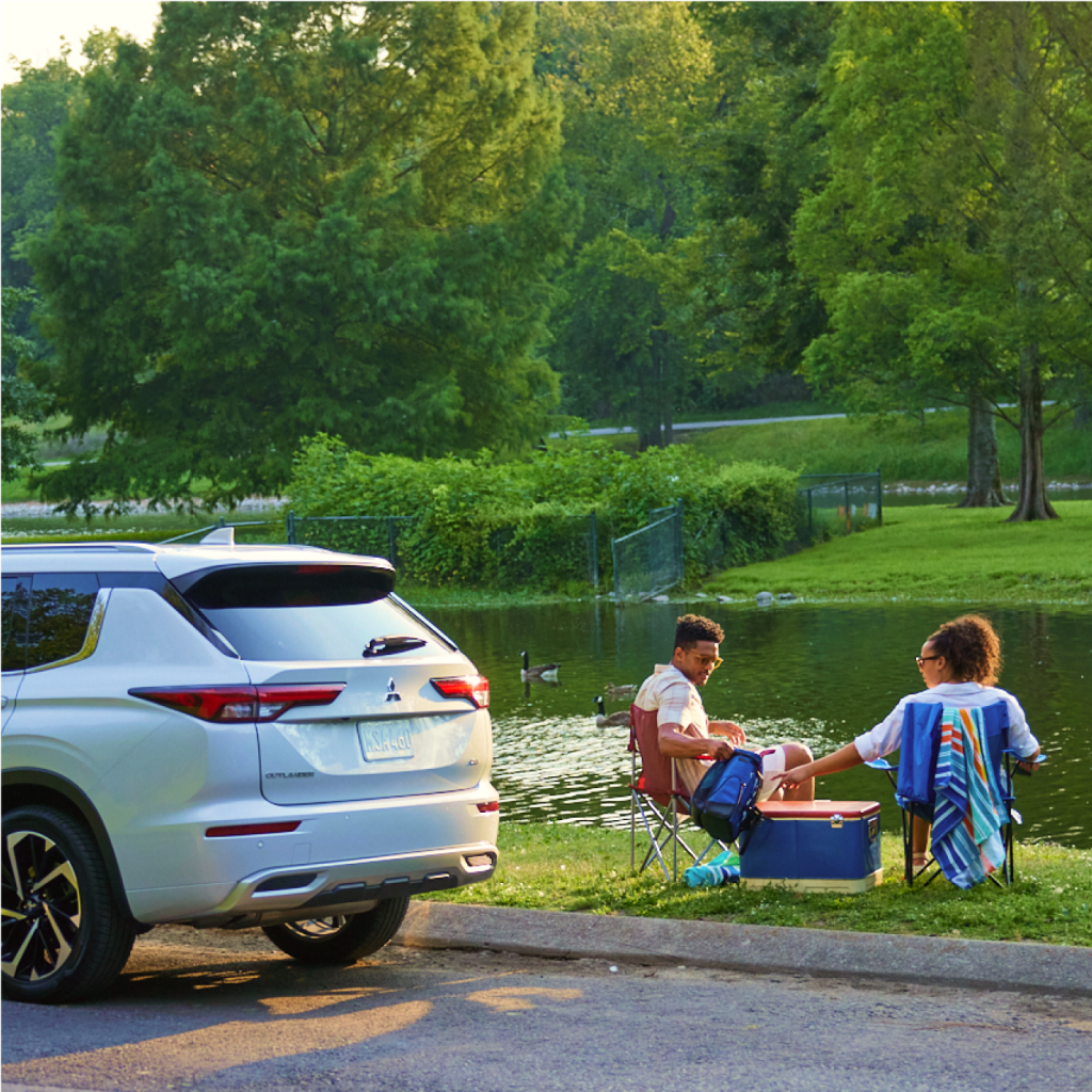 2024 Outlander PHEV SEL people having a picnic near a lake