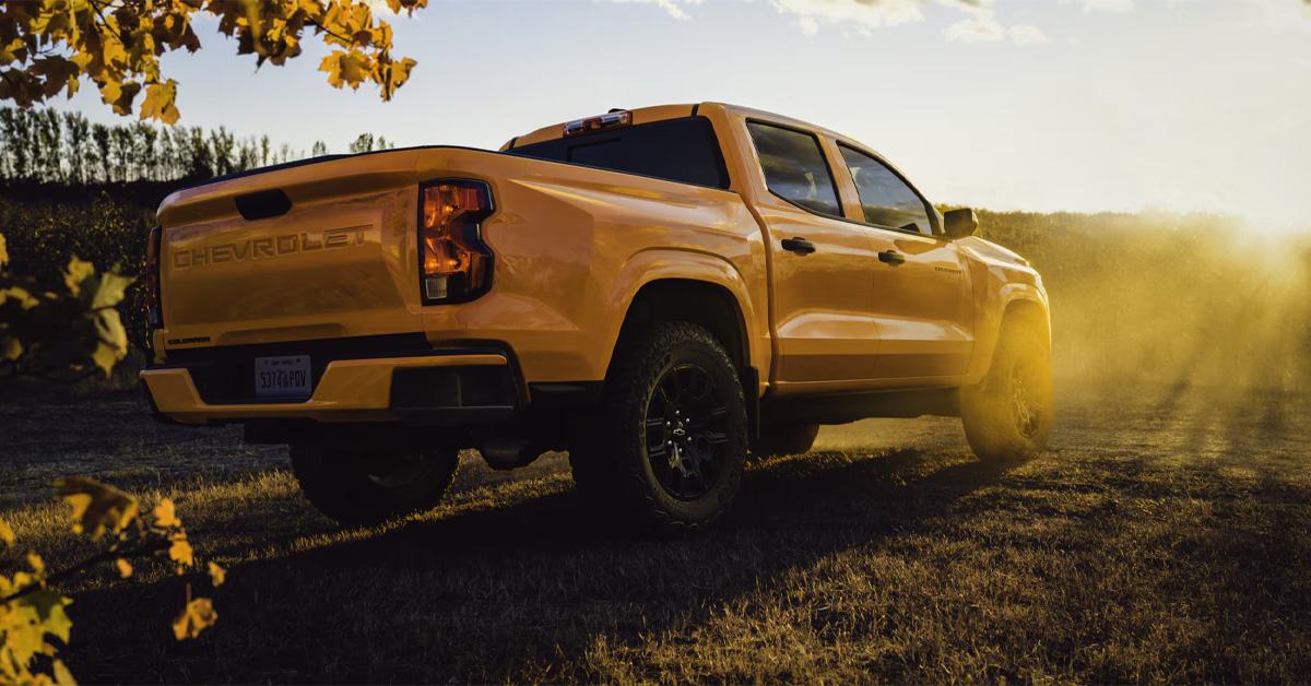 2026 Chevrolet Colorado pickup truck in yellow driving on the grass