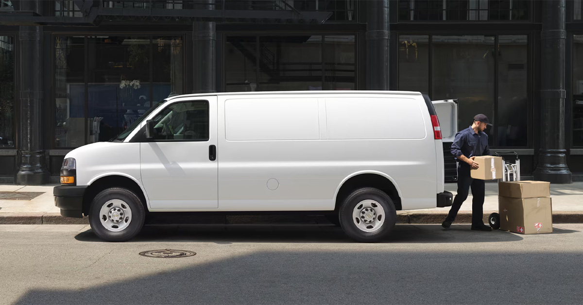 2026 Chevrolet express cargo vans with man unloading boxes from the back