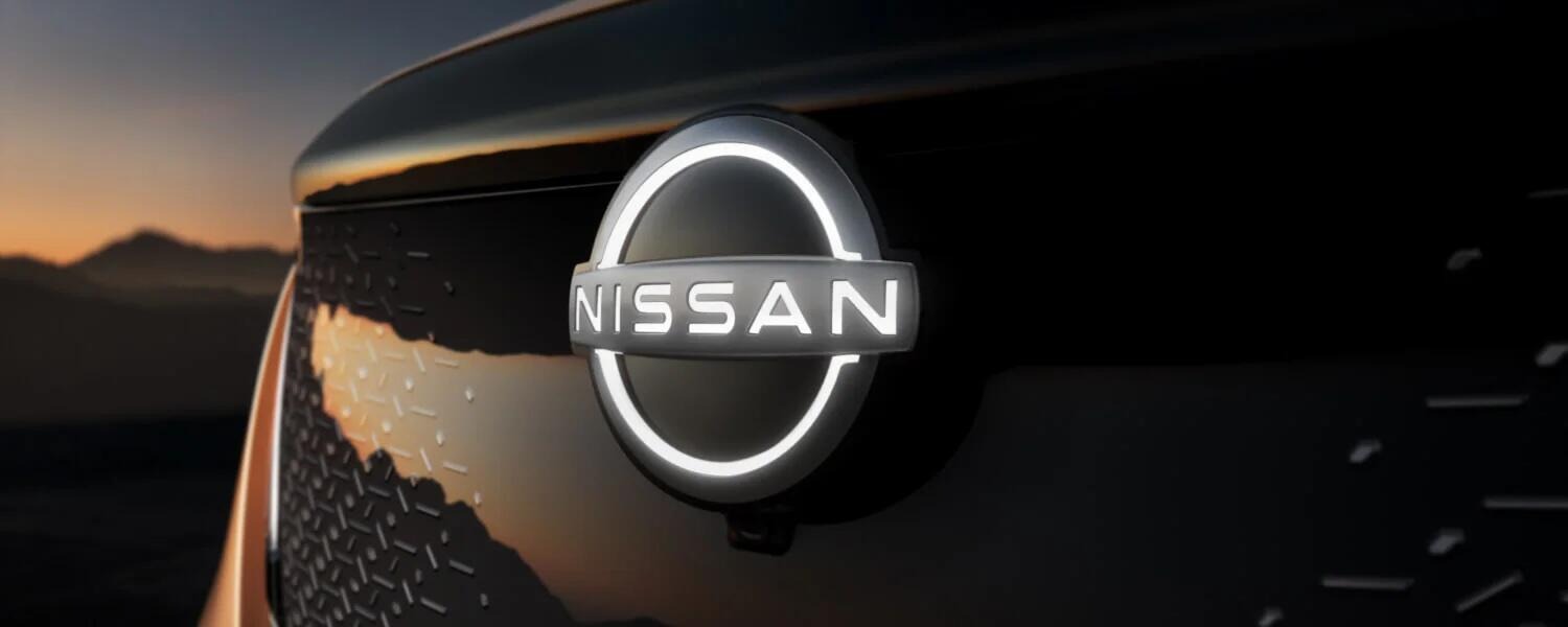 2025 Nissan Ariya a close up photo of the lit up grille of the 2025 nissan ariya