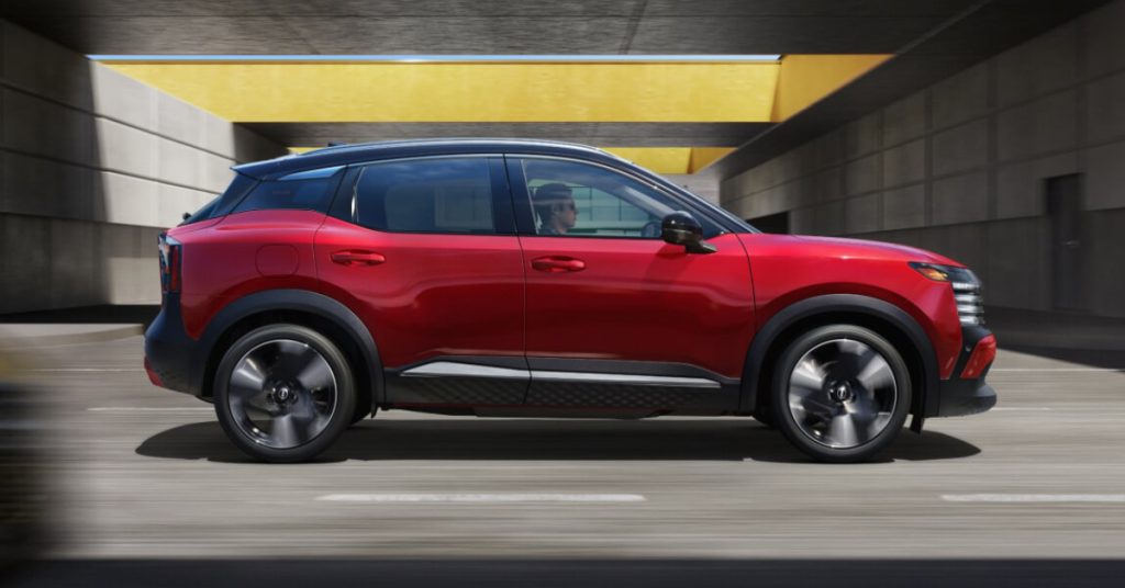 2025 nissan kicks-SR trim in Two-tone Scarlet Ember Tintcoat _ Super Black driving on the highway