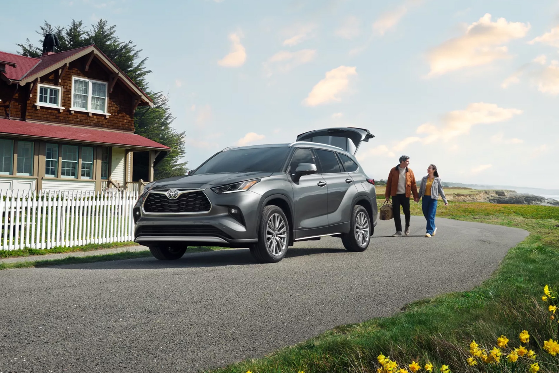 Couple walking to the open trunk of a Toyota SUV