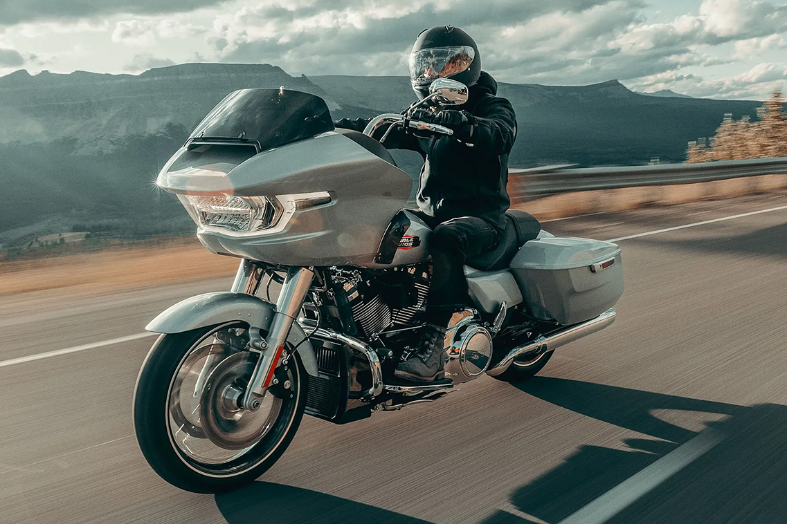 Man riding Harley-Davidson motor cycle in canyon road