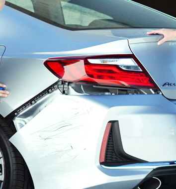 Collision Center Technician Repairing Vehicle