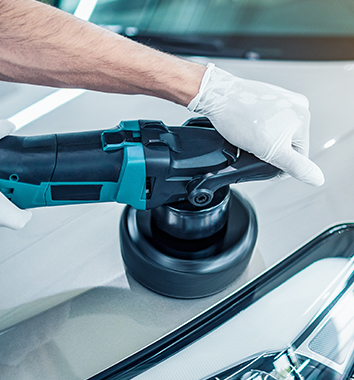 Collision Center Technician Painting a Vehicle