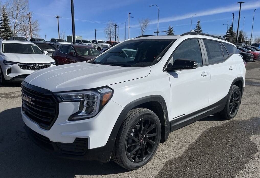 3/4 profile of a new GMC Terrain SLE sitting on a dealership lot
