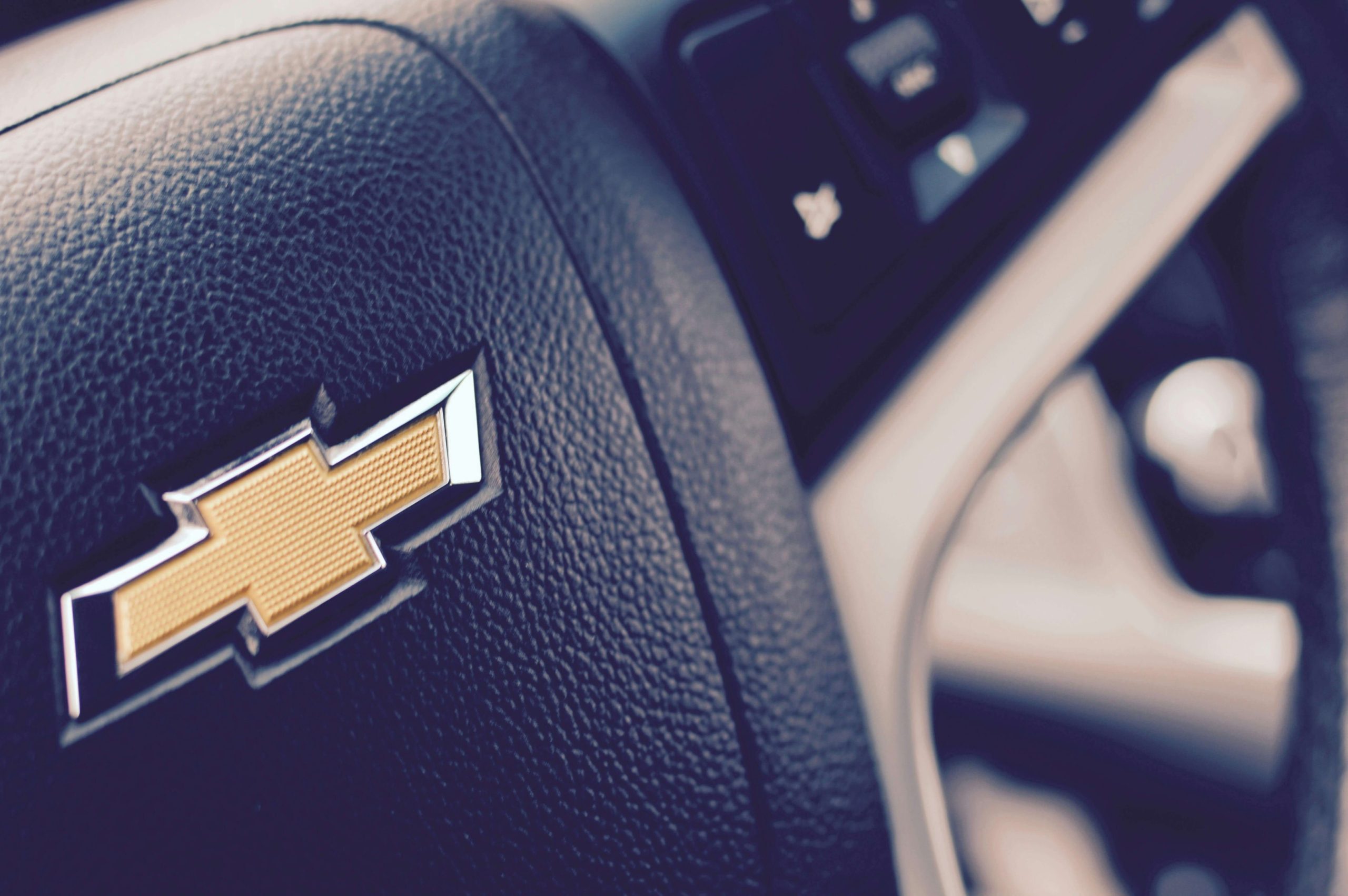 A close up of a Chevrolet steering wheel, showcasing the signature logo.