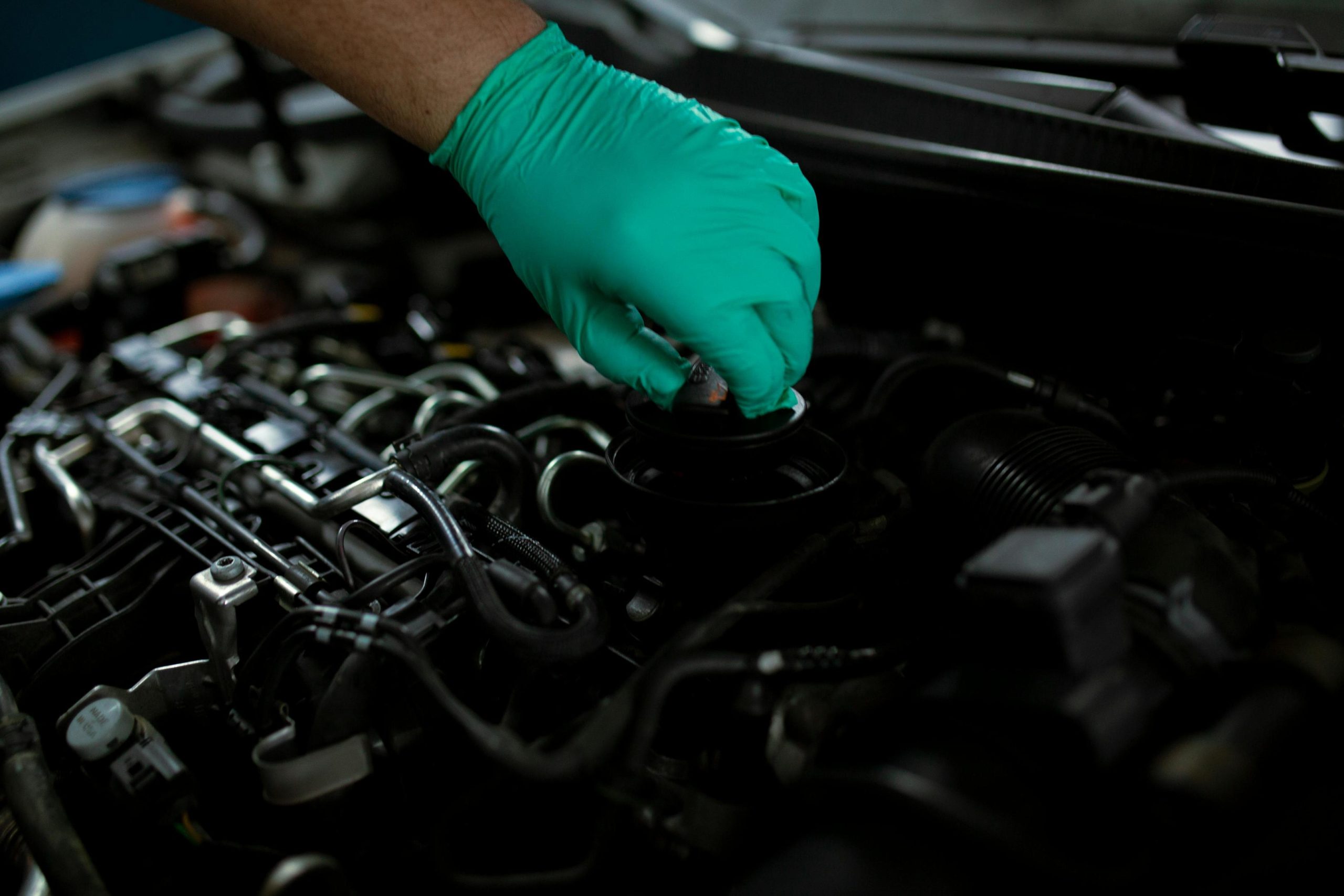 A mechanic checking the engine oil of a vehicle