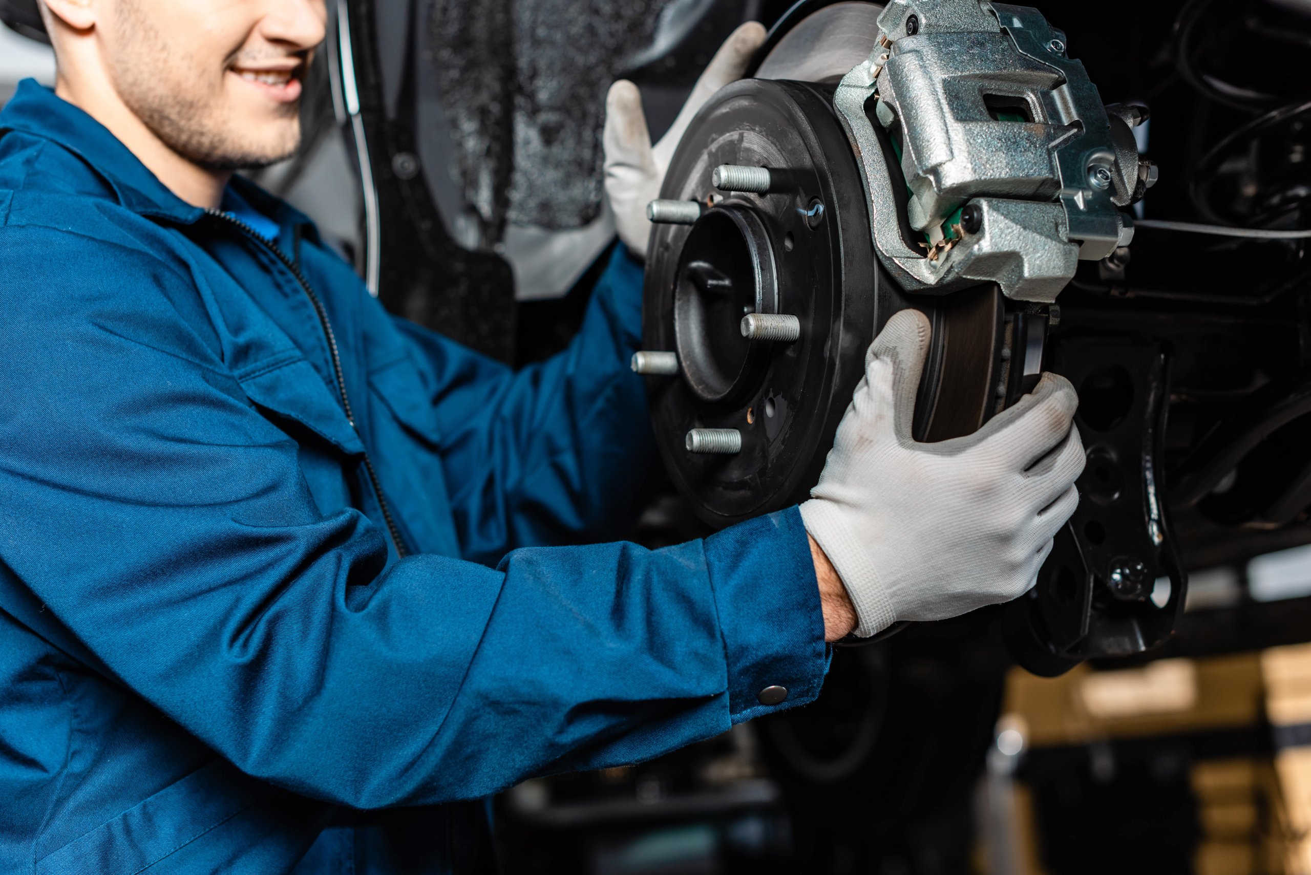 Mechanic fixing the brakes inside of a chevrolet car
