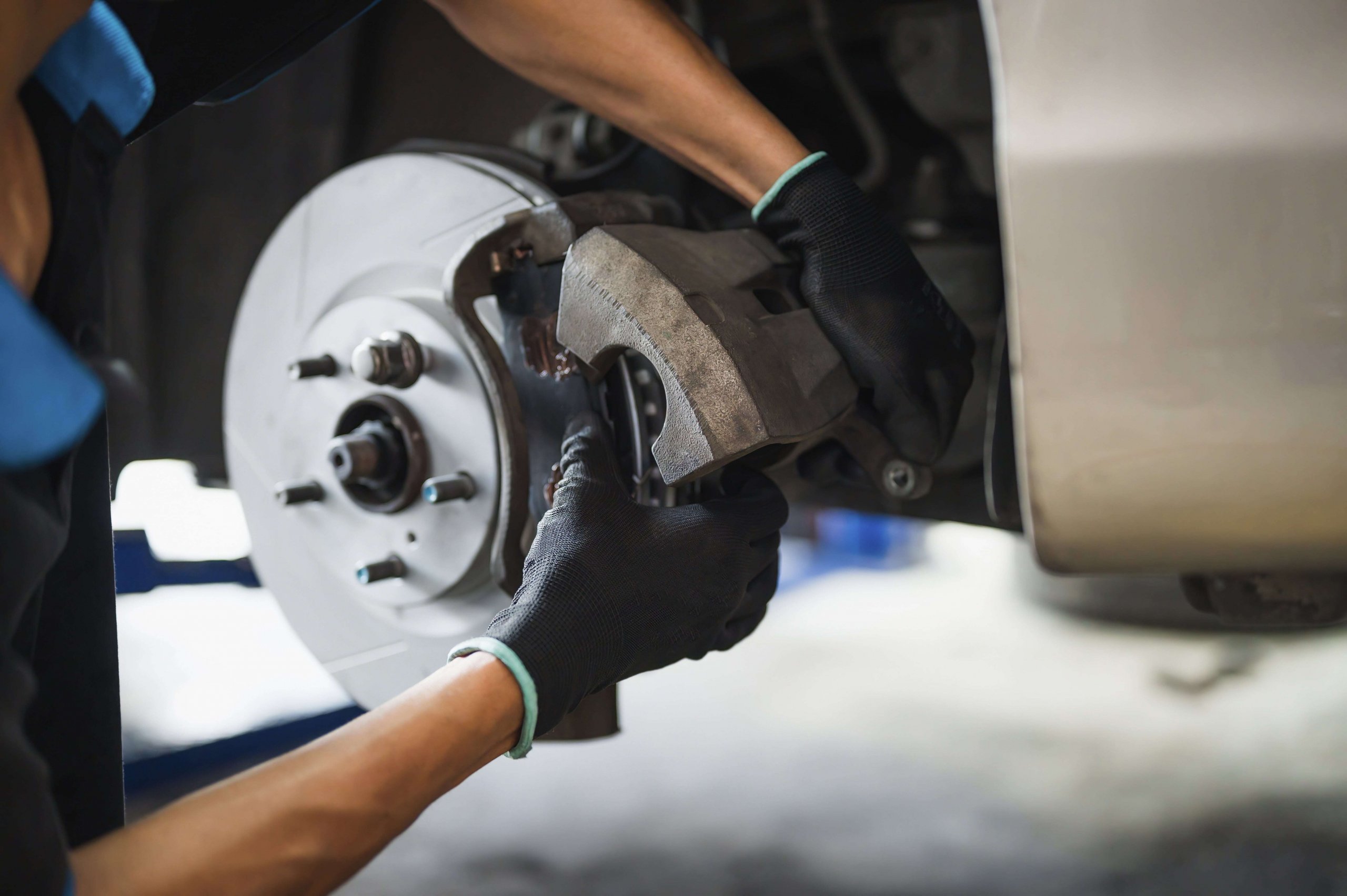 Mechanic working on the brakes of a car