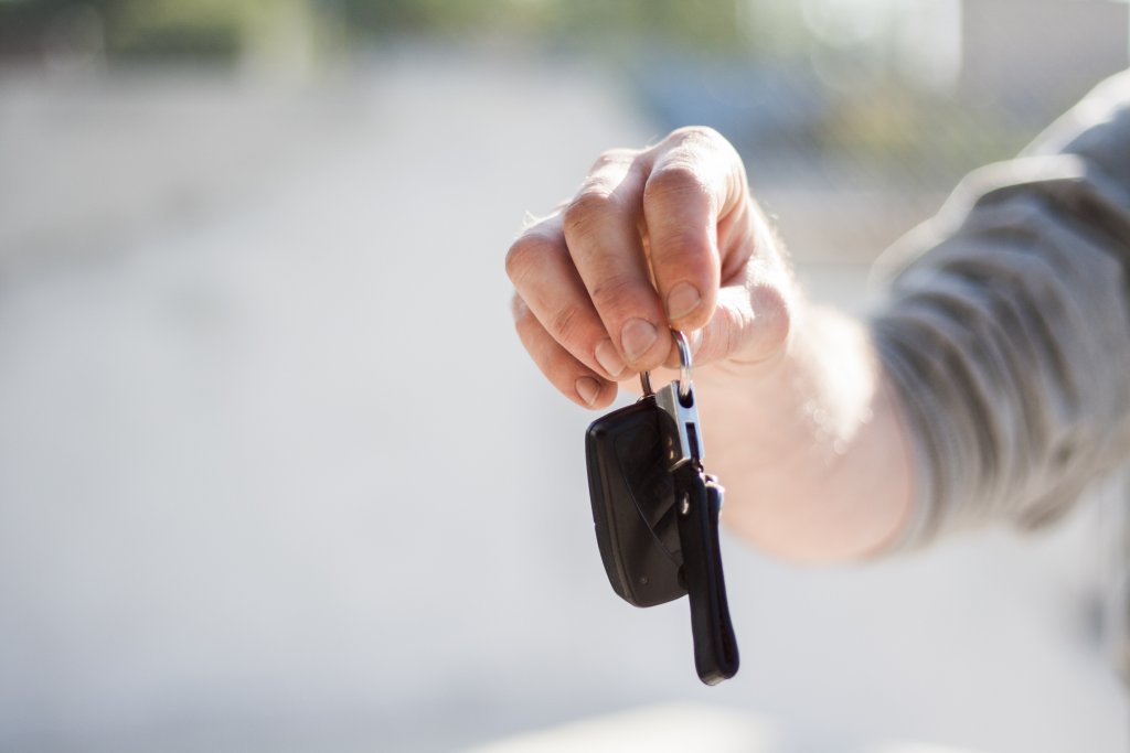 hand holding car keys to SUV