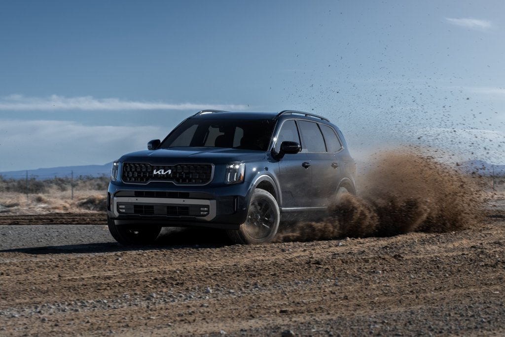 kia suv driving through dirt