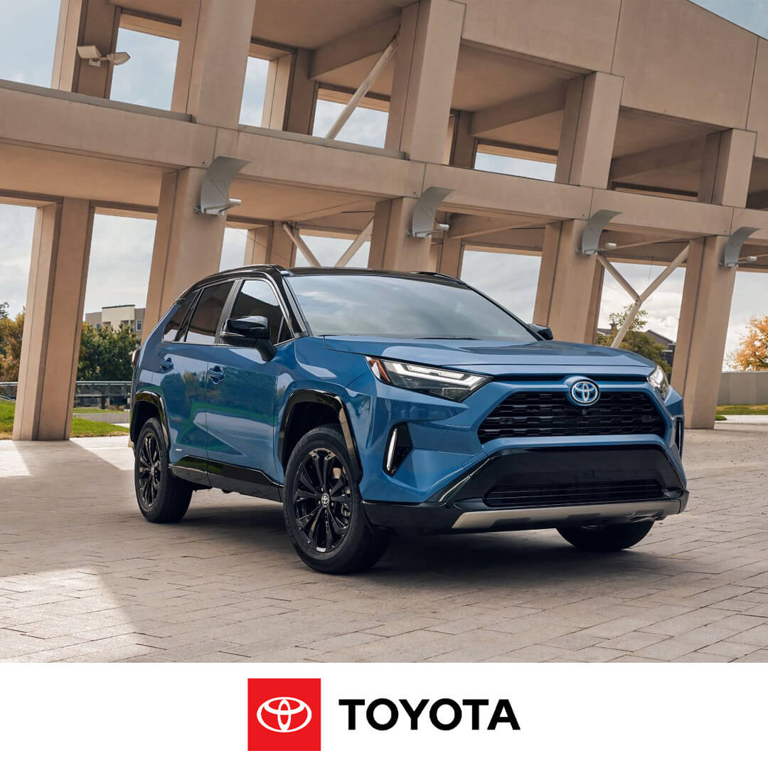 2024 Toyota Rav4 Hybrid parked in front of infrastructure