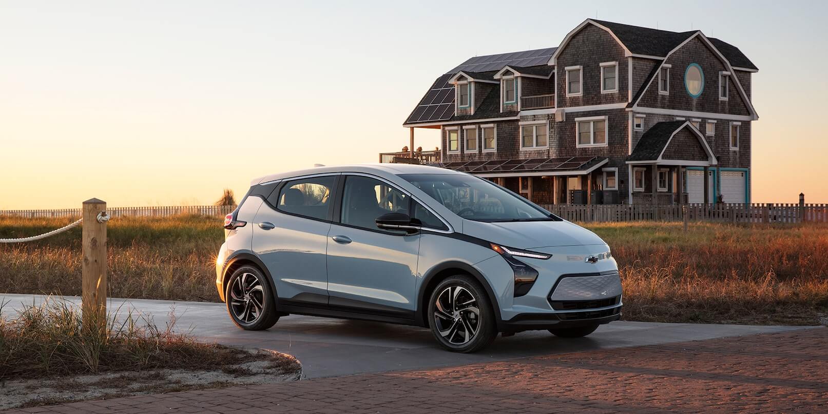 Right-side exterior view of the 2022 Chevrolet Bolt EV driving on the road.