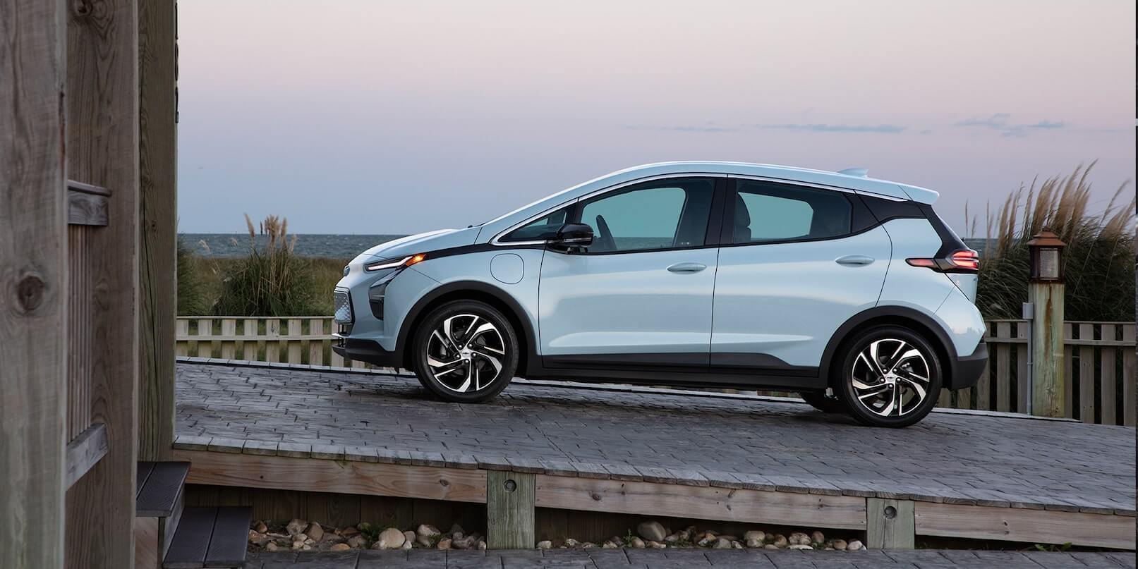 Left-side exterior view of the 2022 Chevrolet Bolt EV parked on an inclined road.