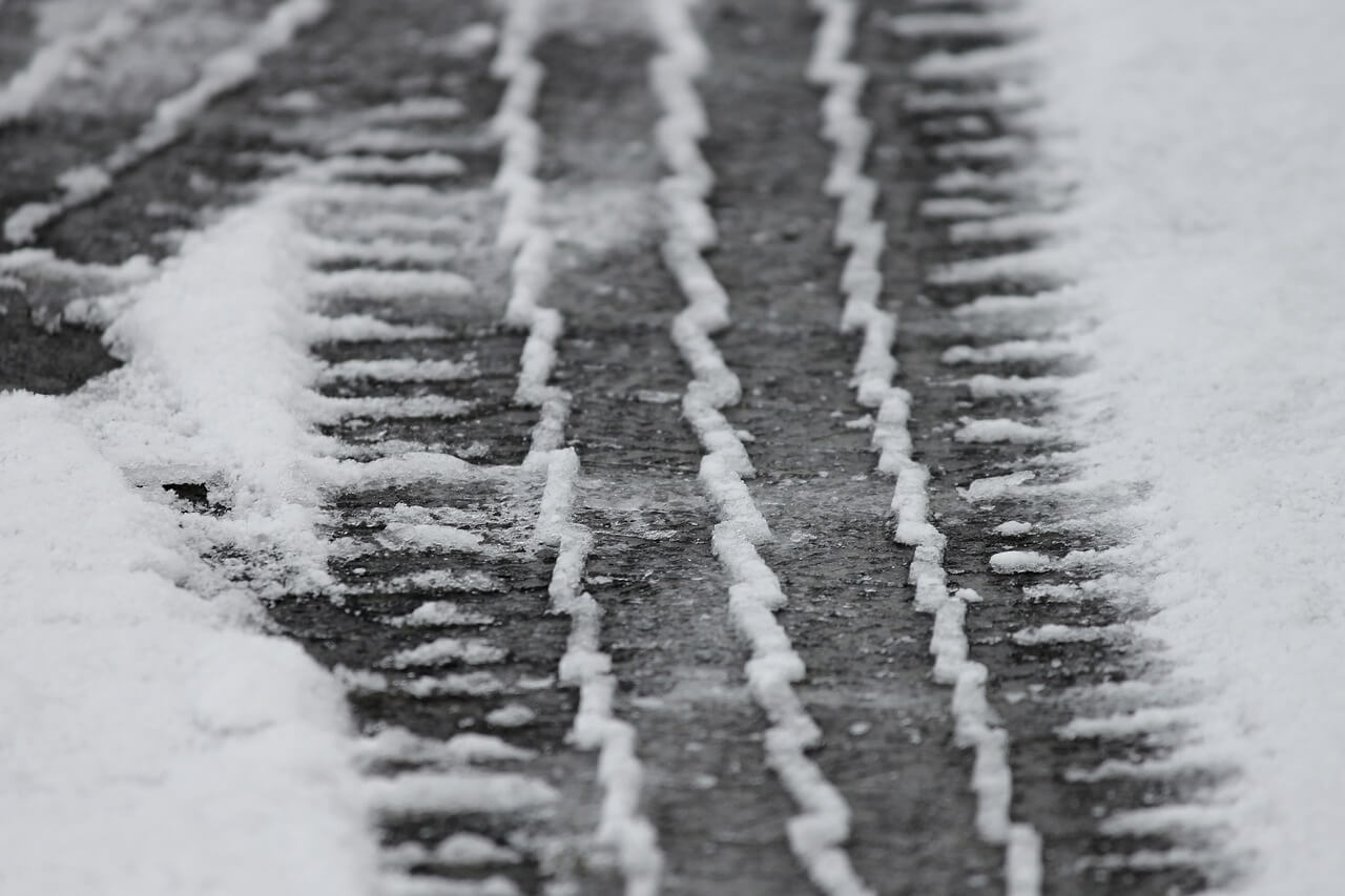 Tire tracks left behind in the snow, showing the depth of the treads on winter tires.