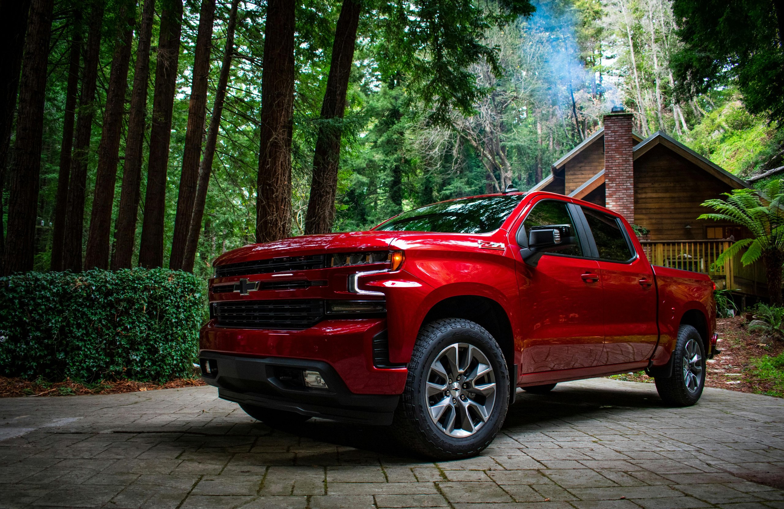 A red Chevrolet Silverado 1500 parked in a residential lot.