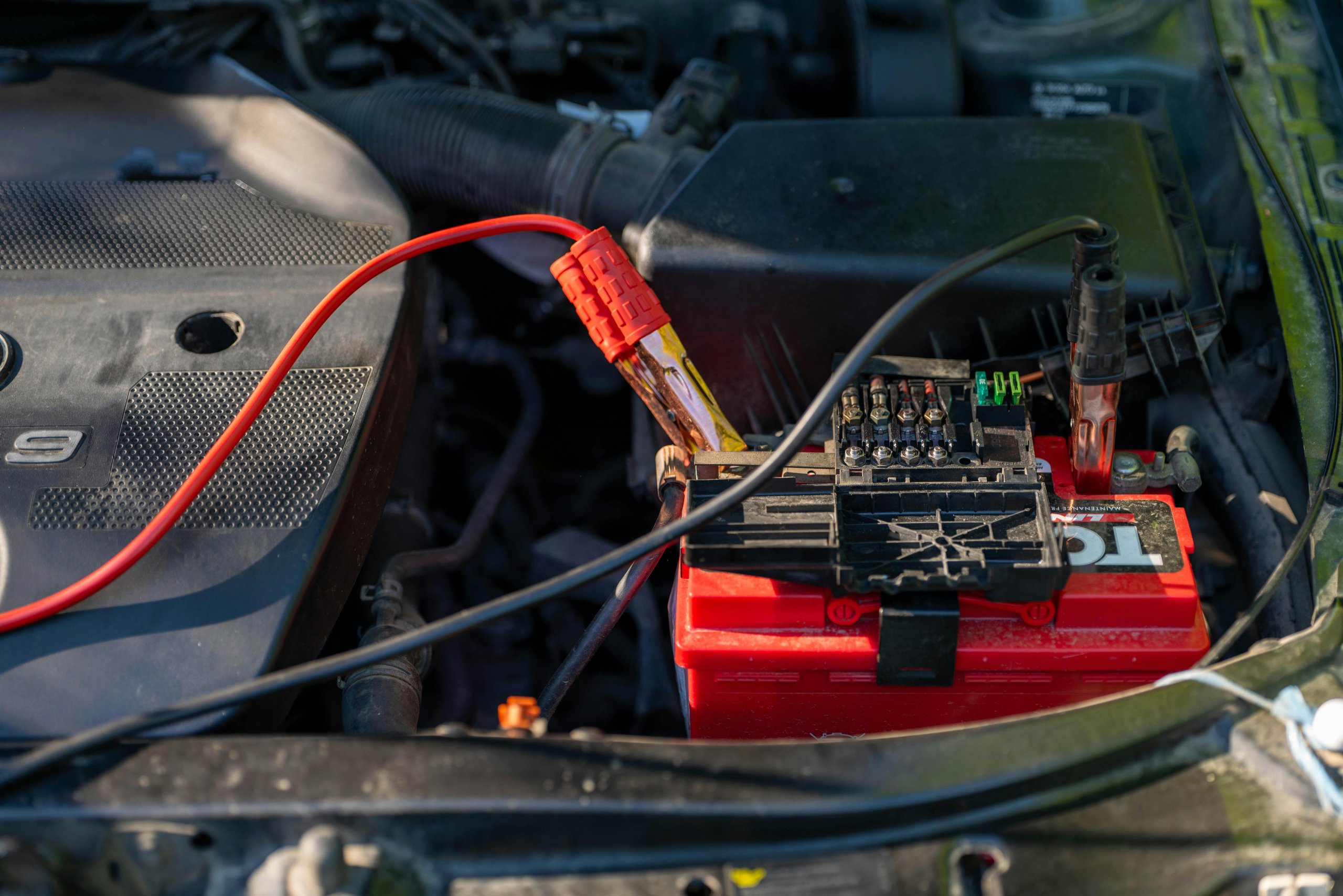 Jumper cables attached to a car battery