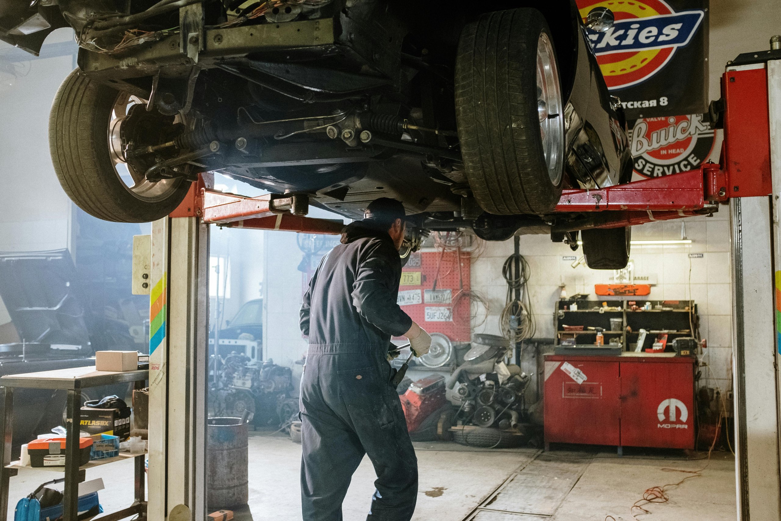A mechanic working on the undercarriage of a vehicle