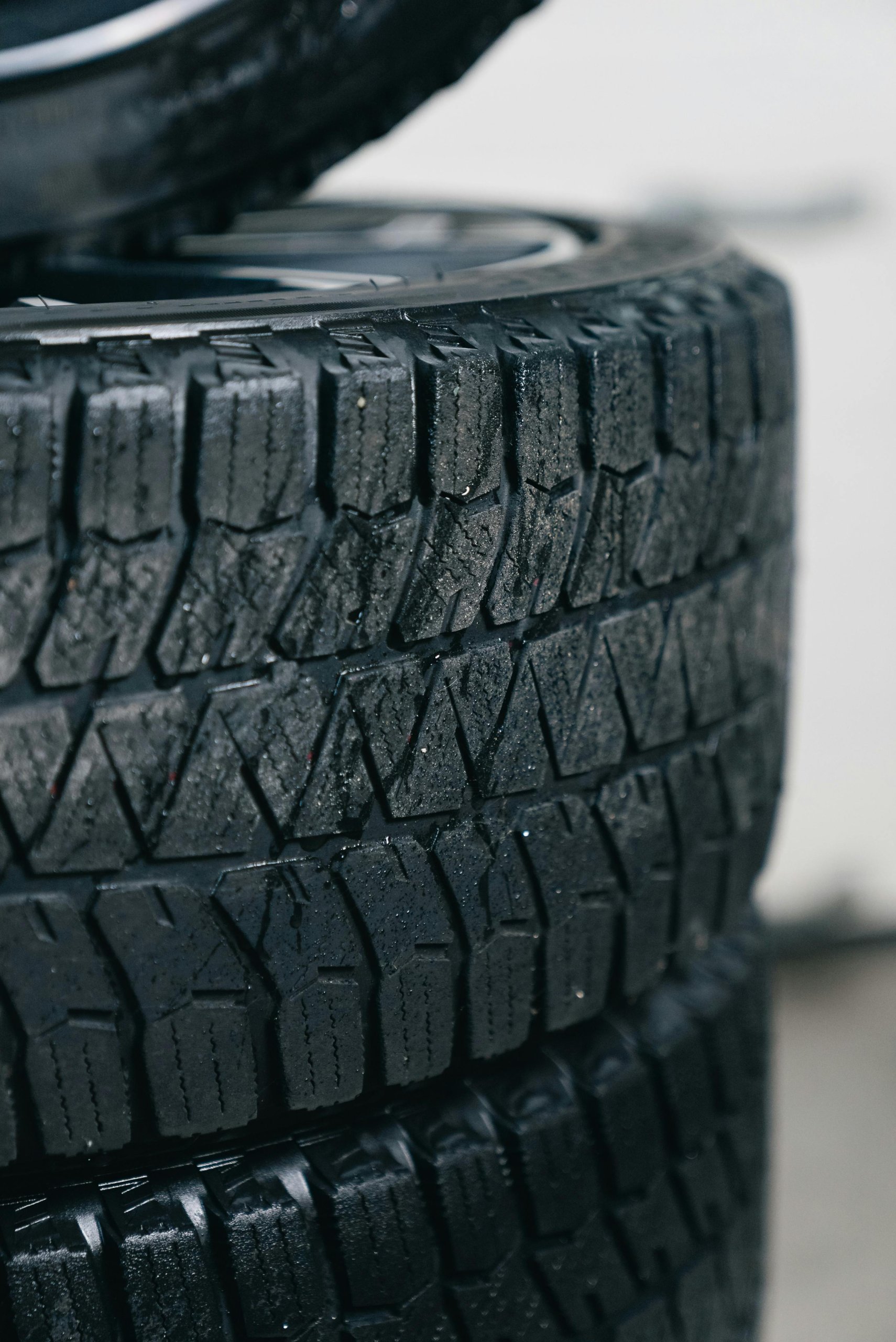 A stack of tires with particular focus on their tread patterns