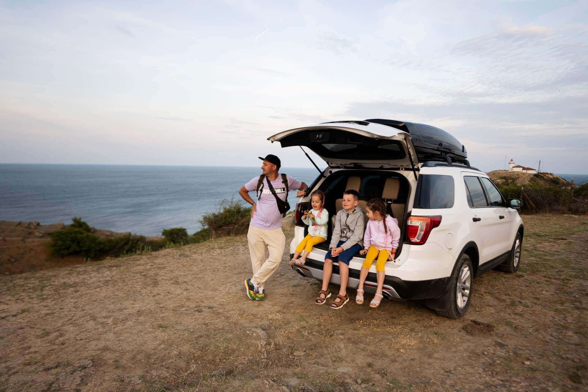 Family taking a seat in open hatch of a compact SUV