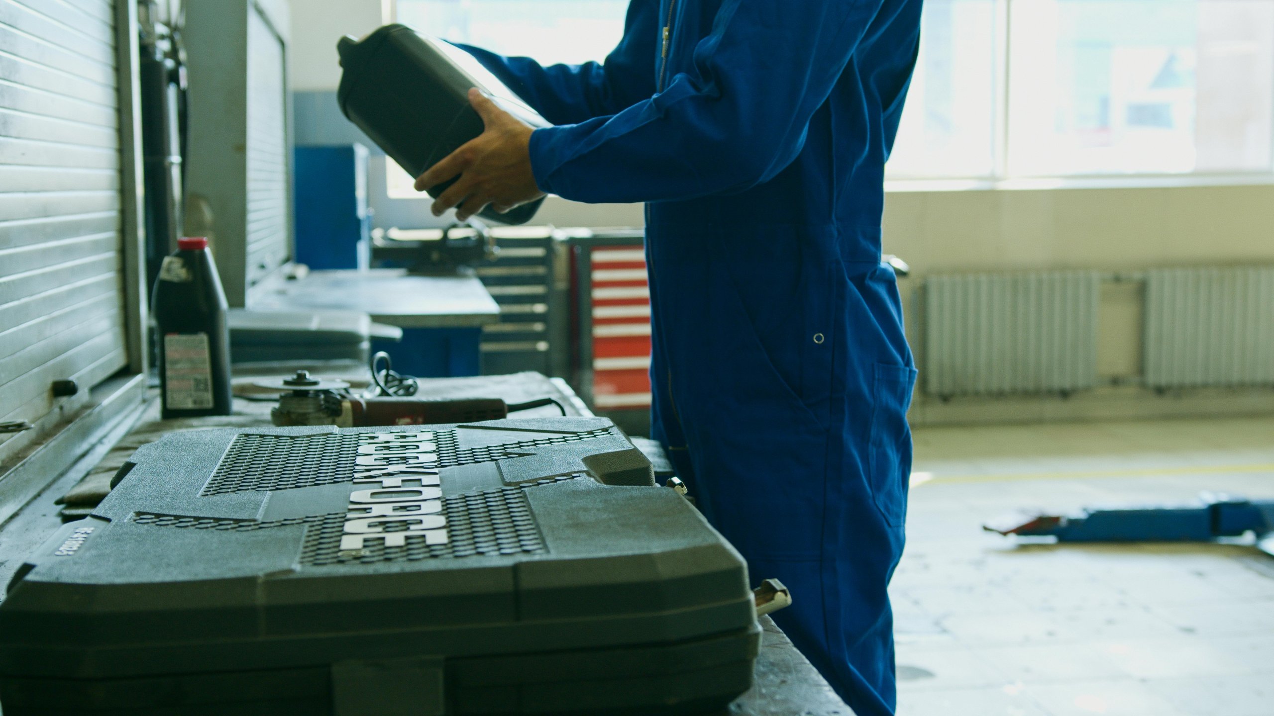 A mechanic examining a bottle of high-quality engine oil