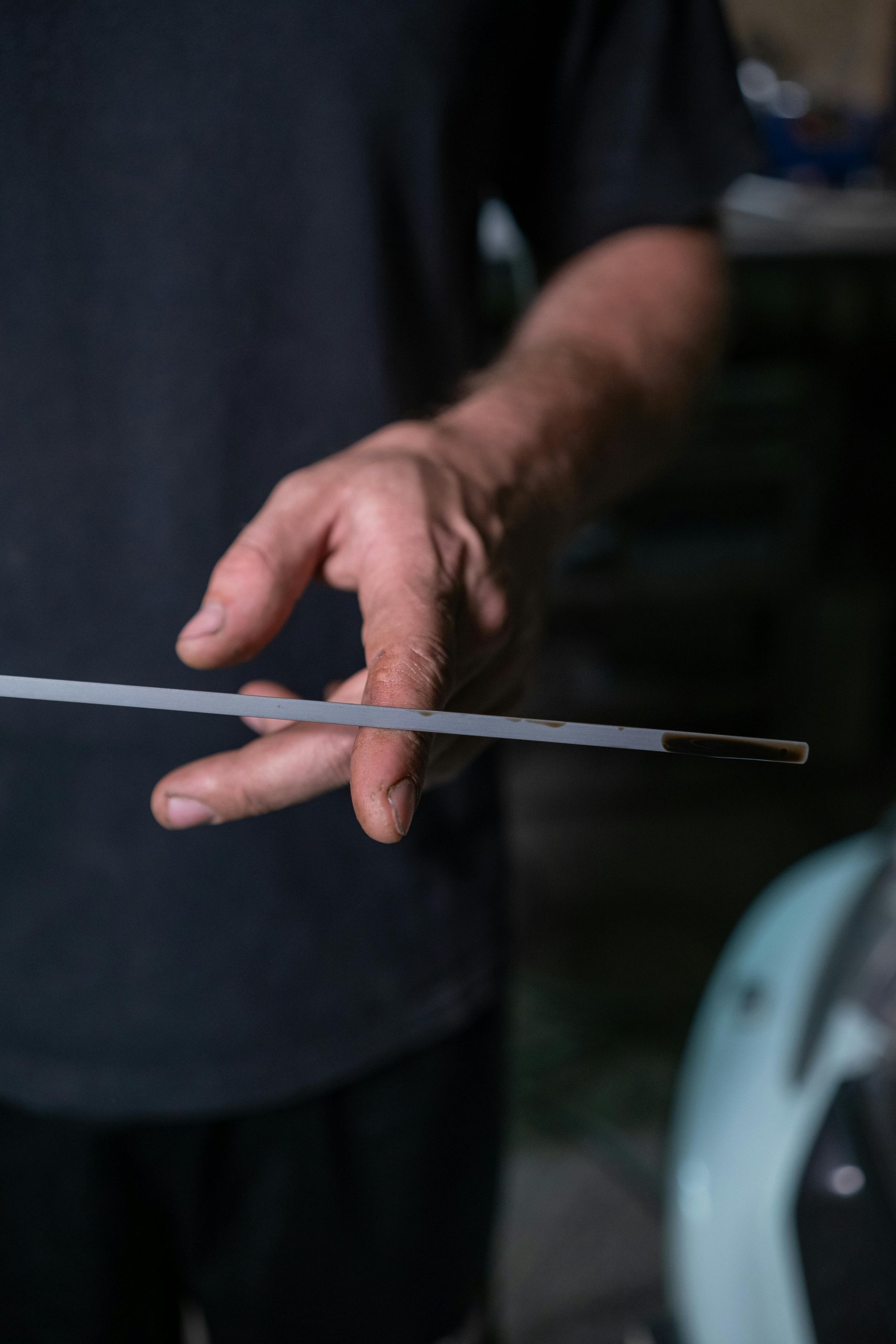 A mechanic checking oil levels using a dipstick