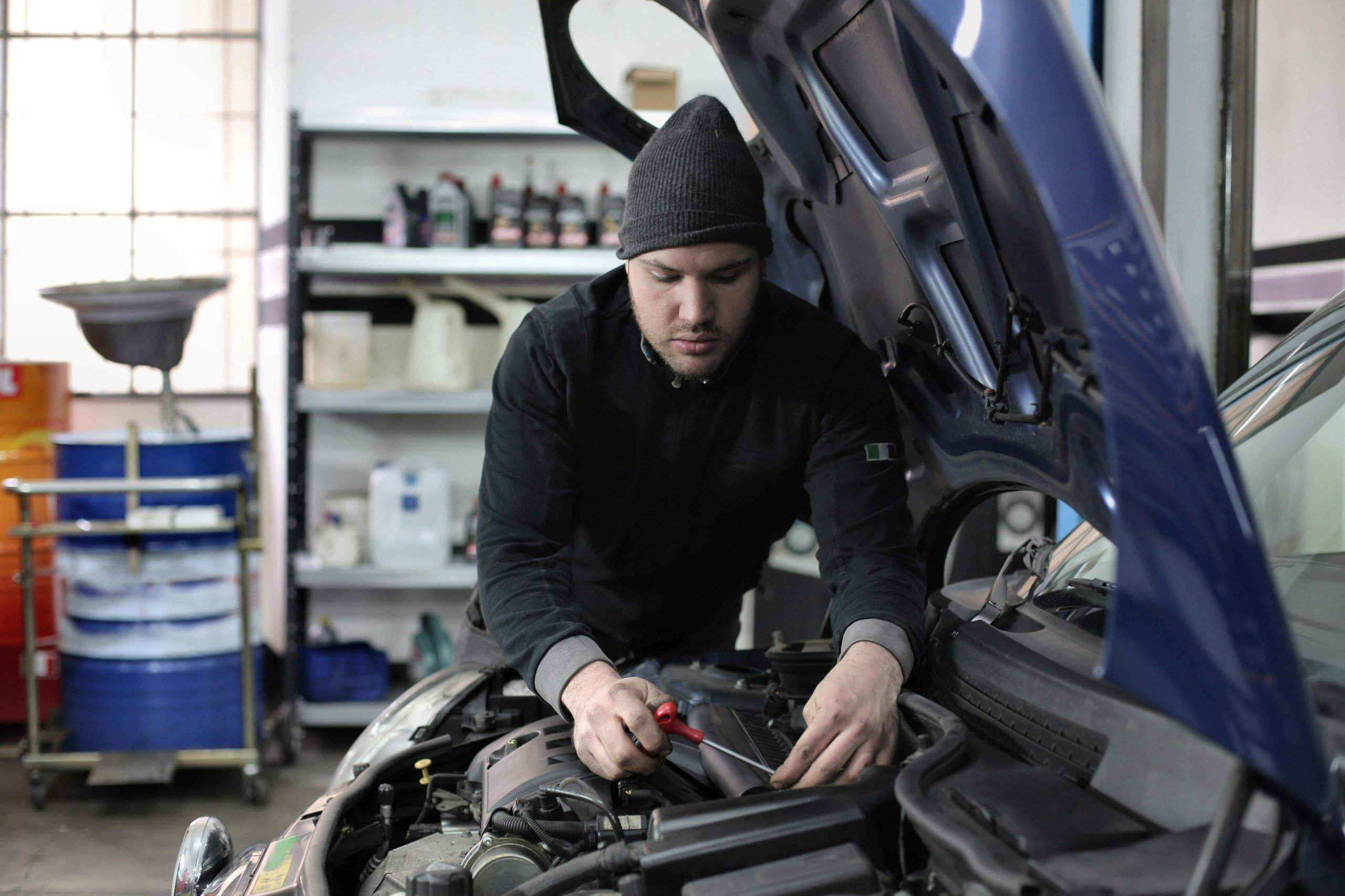 A mechanic performing an oil change on a vehicle