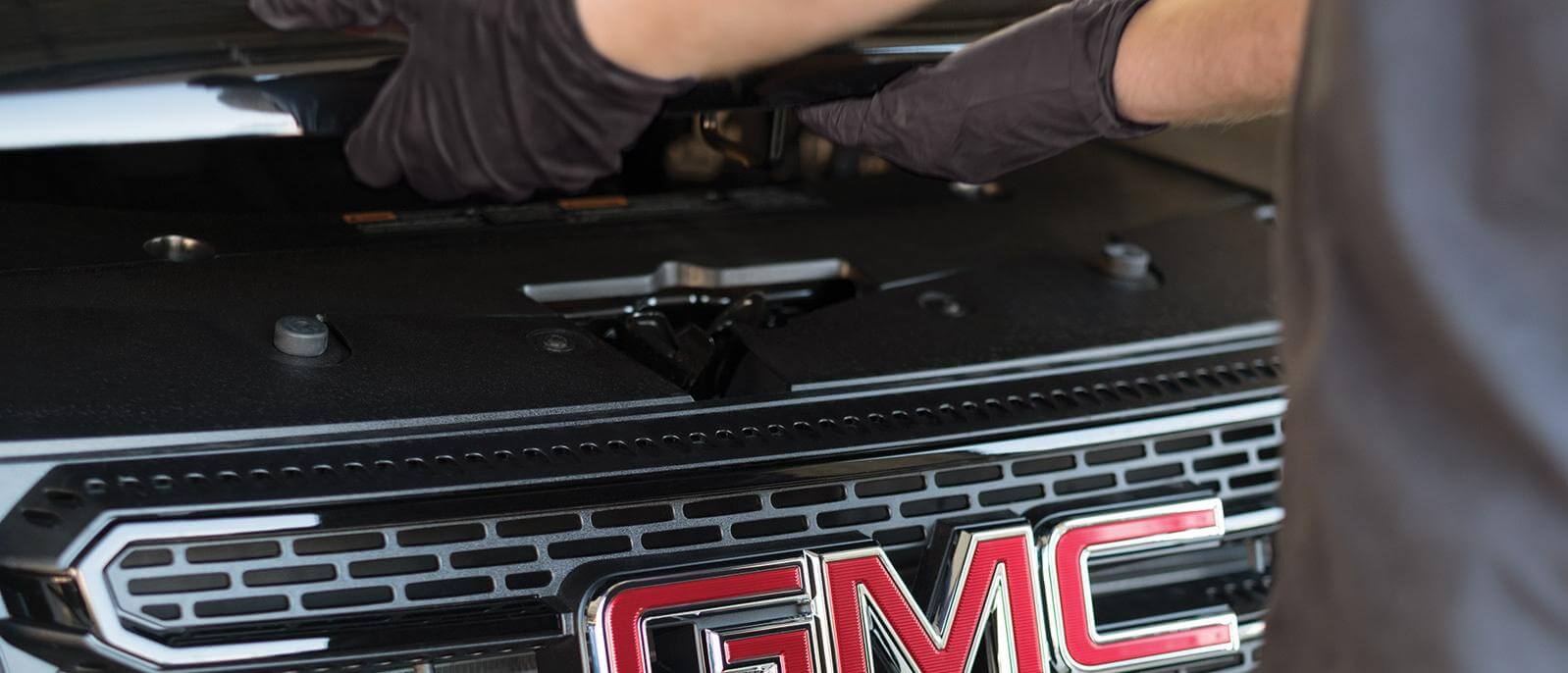 Opening the hood on a GMC