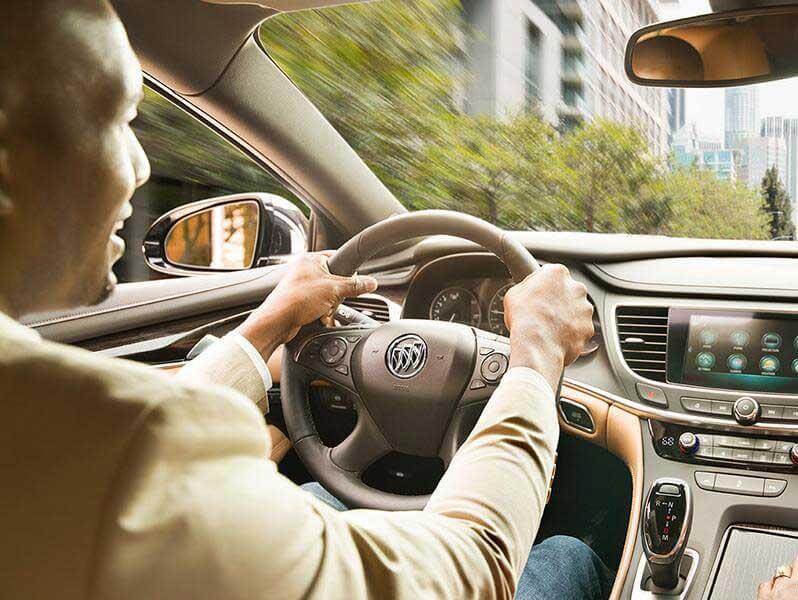 Woman driving a Buick