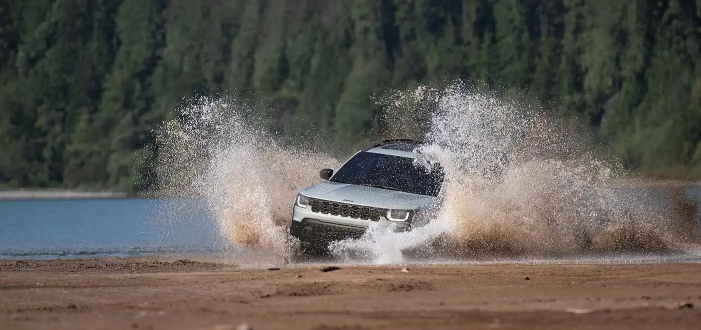 2026 Jeep Cherokee rear three quarter view on an outdoor road