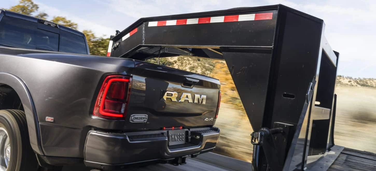 Ram 3500 dually pickup towing a gooseneck flatbed trailer