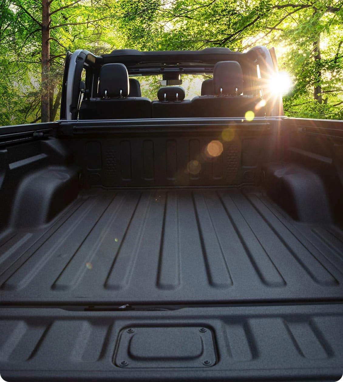Jeep Gladiator with the top open showing the open air cabin and cargo bed
