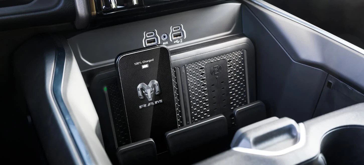 2026 Ram 2500 interior console detail with wireless charging pad and USB ports