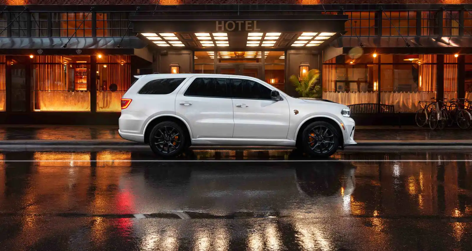 white 2026 Dodge Durango parked on a wet city street at dusk