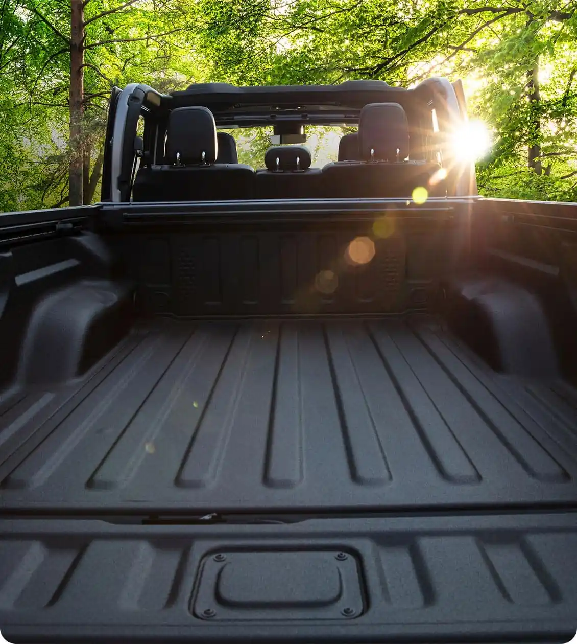 Jeep Gladiator open air cab above an empty spray in bedliner box with the tailgate down