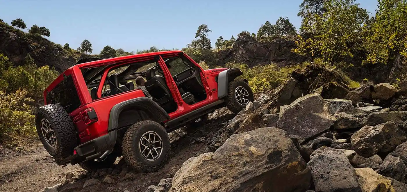 2026 Jeep Wrangler climbing a rocky off road trail
