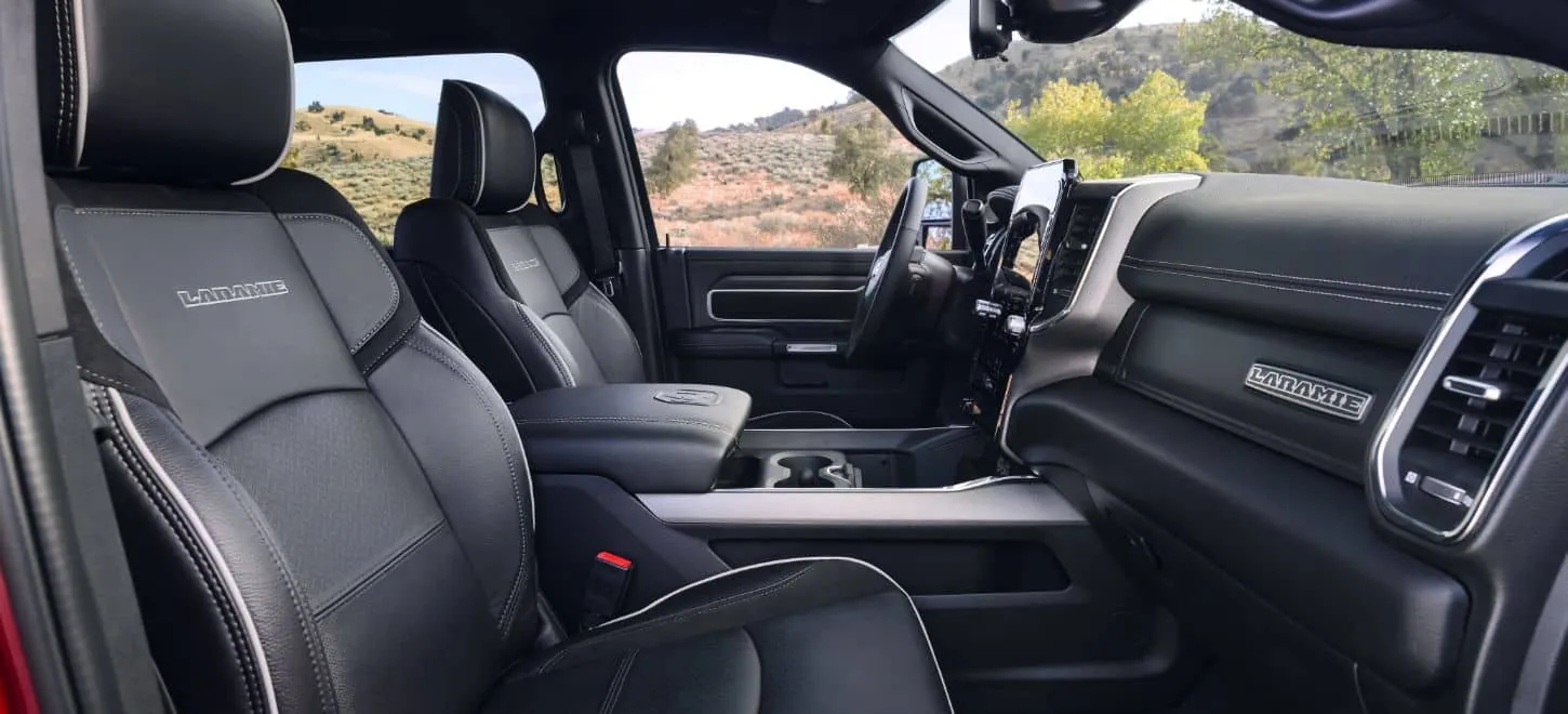 2026 Ram 2500 Laramie front cabin with black leather seats and centre console