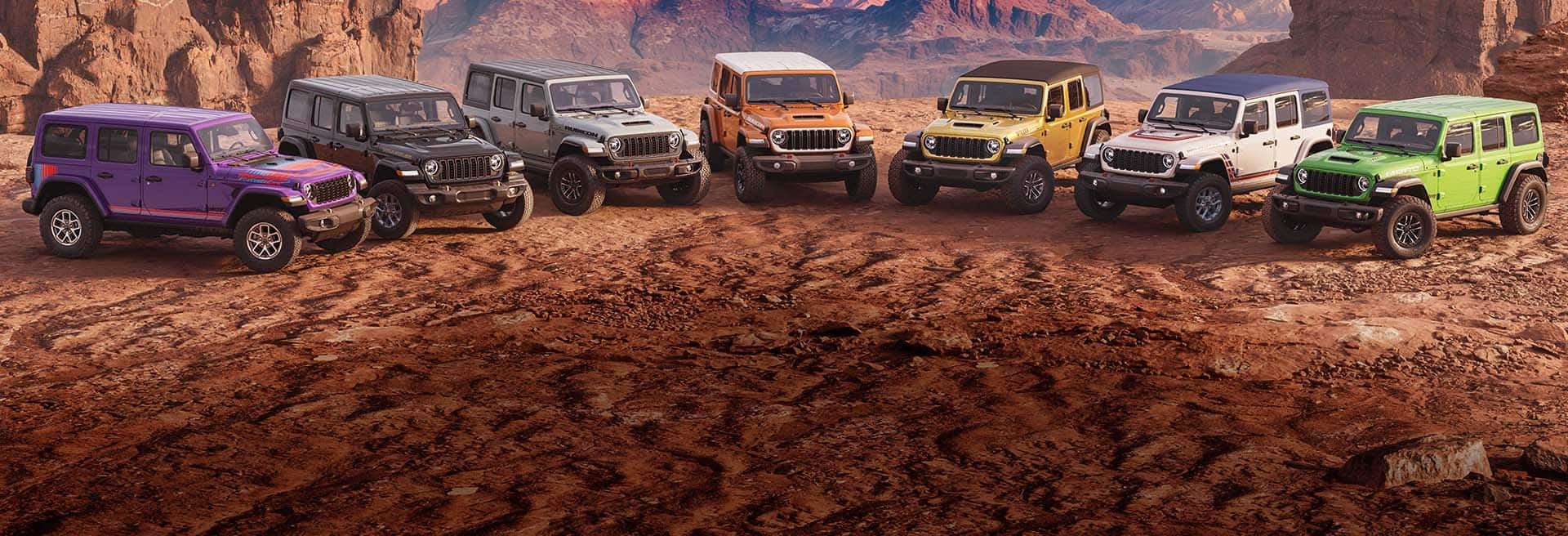 Jeep Wrangler lineup shown together on open terrain
