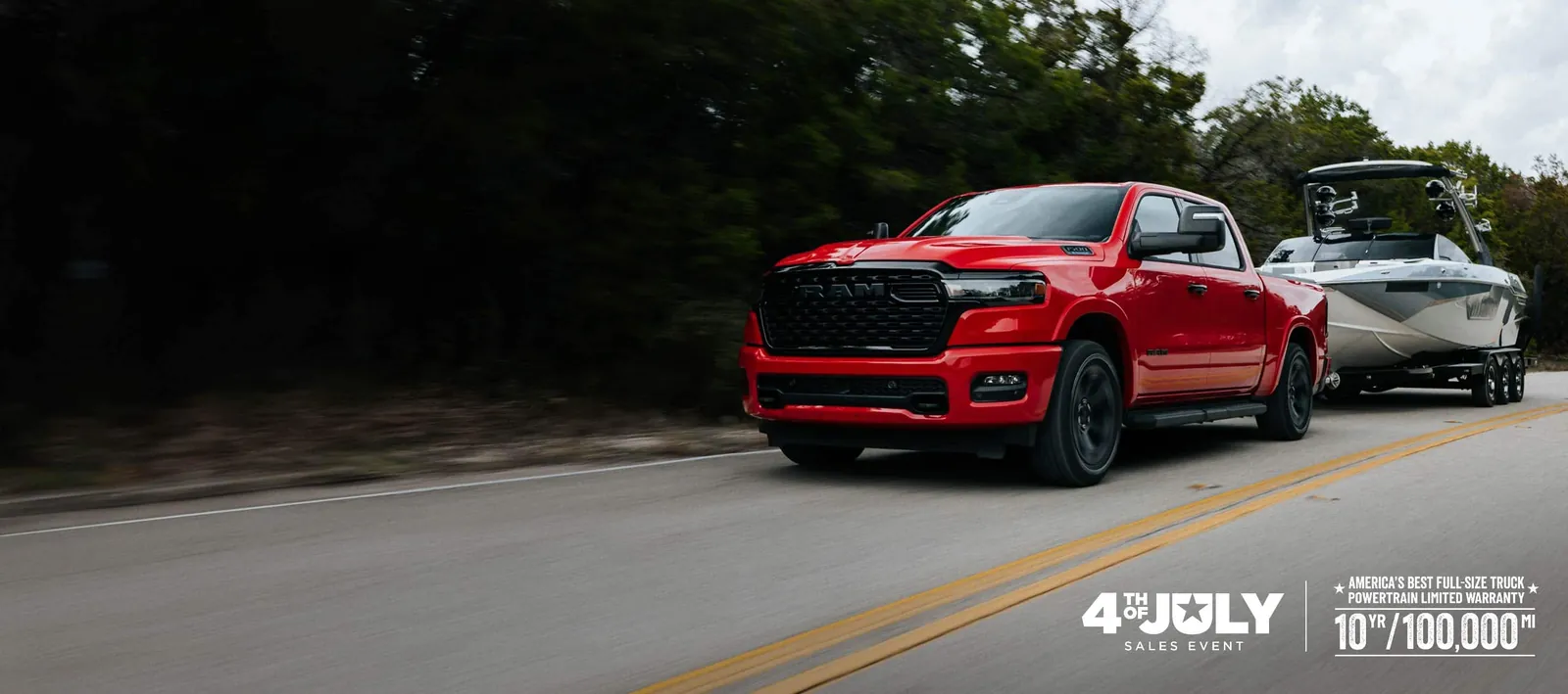 red 2026 Ram 1500 towing a boat on a highway